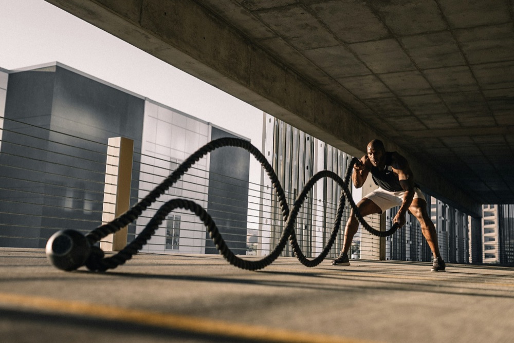 Athlete training with battle ropes